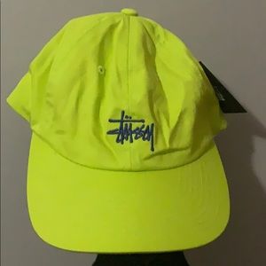 A lime green Stussy hat